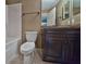 The bathroom features a modern vanity, a large mirror, and a shower-tub combination at 89 Fisher Way Crse, Ocklawaha, FL 32179