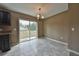 A well-lit dining area with tile flooring, a sliding door, and modern chandelier at 89 Fisher Way Crse, Ocklawaha, FL 32179