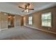Living room with neutral walls, a ceiling fan, carpeting, and a large window at 89 Fisher Way Crse, Ocklawaha, FL 32179
