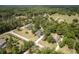 An overhead shot showcasing the home's location amid a serene, wooded neighborhood at 8950 Se 17Th Ct, Ocala, FL 34480
