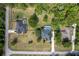 Aerial top down shows a neighborhood including homes with pools and luscious surrounding greenery at 8950 Se 17Th Ct, Ocala, FL 34480