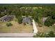 Aerial view of a home with screened in pool and lush green surroundings at 8950 Se 17Th Ct, Ocala, FL 34480