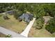 Aerial view of a well-maintained home with a long driveway and mature landscaping at 8950 Se 17Th Ct, Ocala, FL 34480