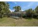 Expansive backyard featuring a screened-in pool area offering privacy and space for outdoor activities and leisure at 8950 Se 17Th Ct, Ocala, FL 34480
