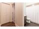 Hallway view of a renovated bathroom with shower and wood-look floors at 8950 Se 17Th Ct, Ocala, FL 34480
