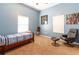 Well-lit bedroom features a single bed, chair, and neutral carpeting at 8950 Se 17Th Ct, Ocala, FL 34480