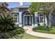 Beautiful home entrance with double doors, decorative glass, and lush landscaping enhancing curb appeal at 8950 Se 17Th Ct, Ocala, FL 34480