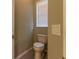 This half bathroom features a toilet and a window at 8950 Se 17Th Ct, Ocala, FL 34480