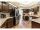 Spacious kitchen with dark cabinets, stainless steel appliances, and granite countertops at 8950 Se 17Th Ct, Ocala, FL 34480
