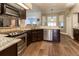 Kitchen showcasing granite countertops, stainless steel appliances, and wood floors at 8950 Se 17Th Ct, Ocala, FL 34480