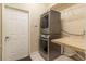 Laundry area with stacked washer and dryer plus countertop and shelving at 8950 Se 17Th Ct, Ocala, FL 34480