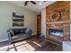 Cozy living room with a wood-paneled fireplace, modern furnishings, and hardwood flooring at 8950 Se 17Th Ct, Ocala, FL 34480