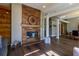 Spacious living area showcasing hardwood floors, fireplace, and open layout connecting to the dining area at 8950 Se 17Th Ct, Ocala, FL 34480