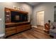 Cozy living room showcasing hardwood floors, custom entertainment center, and neutral color palette at 8950 Se 17Th Ct, Ocala, FL 34480