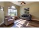 Bright living room featuring hardwood floors, a ceiling fan, and comfortable seating with natural light at 8950 Se 17Th Ct, Ocala, FL 34480