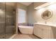 This main bathroom includes a soaking tub, glass shower and modern vanity at 8950 Se 17Th Ct, Ocala, FL 34480