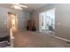 This main bedroom features carpet and sliding glass doors leading to the back patio at 8950 Se 17Th Ct, Ocala, FL 34480
