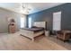 Spacious main bedroom featuring a ceiling fan and two bright, sunny windows at 8950 Se 17Th Ct, Ocala, FL 34480