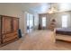 This main bedroom features carpet, a ceiling fan and sliding door access to the backyard at 8950 Se 17Th Ct, Ocala, FL 34480