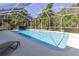 Enjoy the screened pool area, complete with a hot tub, for year-round relaxation and outdoor enjoyment at 8950 Se 17Th Ct, Ocala, FL 34480