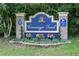 Carriage Trail neighborhood entrance sign beautifully landscaped with flowering plants at 8950 Se 17Th Ct, Ocala, FL 34480