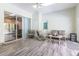 Sunroom features casual seating area, screened windows, and wood-look floors at 8950 Se 17Th Ct, Ocala, FL 34480