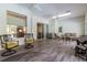 Spacious sunroom has high ceilings, wood-look flooring, and multiple seating areas at 8950 Se 17Th Ct, Ocala, FL 34480
