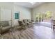 Sunroom features casual seating area, screened windows, and wood-look floors at 8950 Se 17Th Ct, Ocala, FL 34480