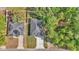Birds eye view displays the property's layout, roof, landscaping, and proximity to neighboring homes and lush greenery at 9405 Se 159Th Ln, Summerfield, FL 34491