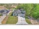 Aerial view of the home showcasing its layout, surrounding landscape, long driveway and a two-car garage at 9405 Se 159Th Ln, Summerfield, FL 34491