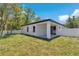 Newly built home with a spacious backyard, a covered patio, and a privacy fence at 9405 Se 159Th Ln, Summerfield, FL 34491