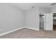 A light and bright bedroom leads to a bathroom with light gray cabinetry at 9405 Se 159Th Ln, Summerfield, FL 34491