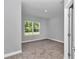 Bedroom featuring light gray walls, neutral carpet, and bright window view at 9405 Se 159Th Ln, Summerfield, FL 34491