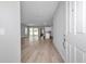 Inviting entryway with an open floor plan, wood floors, and light gray walls at 9405 Se 159Th Ln, Summerfield, FL 34491