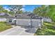 Stylish single-story home with a two-car garage, modern finishes, and a well-maintained front yard at 9405 Se 159Th Ln, Summerfield, FL 34491