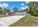 This home features a modern exterior with a two-car garage, well-kept lawn, and a clean, inviting curb appeal at 9405 Se 159Th Ln, Summerfield, FL 34491