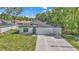 Charming single-story home with a two-car garage, landscaped front yard, and modern architectural details at 9405 Se 159Th Ln, Summerfield, FL 34491