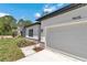 The house showcases a garage with stone accents, manicured landscaping, and a bright, modern aesthetic at 9405 Se 159Th Ln, Summerfield, FL 34491