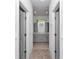 Hallway view of a bathroom with double sinks and cabinets, offering a glimpse of luxury and functionality at 9405 Se 159Th Ln, Summerfield, FL 34491