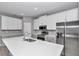 Modern kitchen featuring a large center island, white cabinets, and stainless steel appliances at 9405 Se 159Th Ln, Summerfield, FL 34491