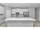 Modern kitchen featuring a large center island, white cabinets, and stainless steel appliances at 9405 Se 159Th Ln, Summerfield, FL 34491