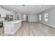 Open-concept living space featuring luxury vinyl floors, lots of natural light, and adjacent kitchen at 9405 Se 159Th Ln, Summerfield, FL 34491