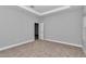 Large bedroom with tray ceiling, neutral wall color, and plush carpet flooring at 9405 Se 159Th Ln, Summerfield, FL 34491