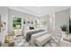 Bright, modern main bedroom featuring tray ceilings, ample natural light, and elegant furnishings at 9405 Se 159Th Ln, Summerfield, FL 34491