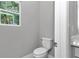 Modern toilet with a window view providing natural light and ventilation at 9405 Se 159Th Ln, Summerfield, FL 34491