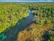 Stunning aerial view of a crystal-clear river flowing through a lush green forest at 9525 Sw 200 Ct, Dunnellon, FL 34431