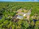 A bird's-eye view of a charming home nestled in a lush, wooded neighborhood at 9525 Sw 200 Ct, Dunnellon, FL 34431