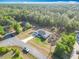 Expansive aerial shot showcasing a well-maintained home, driveway and lush surrounding greenery at 9525 Sw 200 Ct, Dunnellon, FL 34431