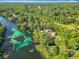 Scenic aerial view of a riverfront property nestled among verdant trees and clear waters at 9525 Sw 200 Ct, Dunnellon, FL 34431
