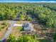 Aerial view of home on wooded lot with long driveway and ample parking at 9525 Sw 200 Ct, Dunnellon, FL 34431